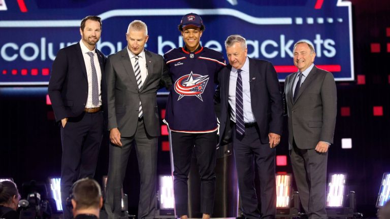 Cayden Lindstrom, centre, poses after being selected by the Columbus Blue Jackets during the first round round of the NHL hockey draft Friday, June 28, 2024, in Las Vegas. (Steve Marcus/AP)