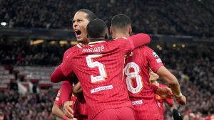 Liverpool's Virgil van Dijk, center left, celebrates after Cody Gakpo scored their second goal during the Champions League opening phase soccer match between Liverpool and Real Madrid at Anfield Stadium, Liverpool, England, Wednesday, Nov. 27, 2024. (Jon Super/AP)