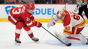 Calgary Flames goaltender Dan Vladar (80) stops a shot by Detroit Red Wings left wing Lucas Raymond (23) during the second period of an NHL hockey game. (Carlos Osorio/AP)