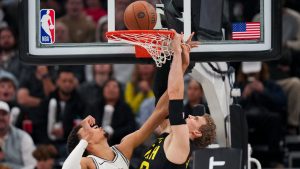 Utah Jazz forward Lauri Markkanen (23) tries to dunk the ball as San Antonio Spurs center Victor Wembanyama (1) defends during the second half of an NBA basketball game. (Bethany Baker/AP)