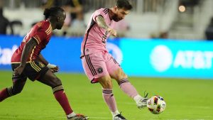 Inter Miami forward Lionel Messi (10) passes the ball as Atlanta United midfielder Tristan Muyumba (8) attempts to defend during the first half of their MLS playoff opening round soccer match, Saturday, Nov. 9, 2024, in Fort Lauderdale, Fla. (Rebecca Blackwell/AP)