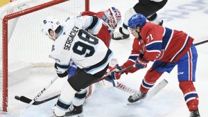 Utah Hockey Club's Mikhail Sergachev scores against Montreal Canadiens goaltender Sam Montembeault as Canadiens' Jake Evans defends during overtime NHL action in Montreal, Tuesday, November 26, 2024. (THE CANADIAN PRESS/Graham Hughes)