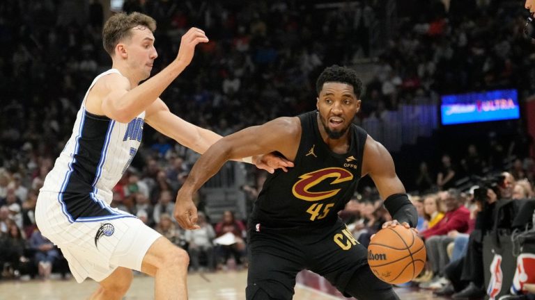 Cleveland Cavaliers guard Donovan Mitchell (45) drives past Orlando Magic forward Franz Wagner, left, in the first half of an NBA game, Friday, Nov. 1, 2024, in Cleveland. (Sue Ogrocki/AP Photo)