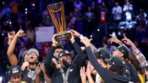 Los Angeles Lakers forward LeBron James, centre, lifts the the NBA Cup while celebrating with teammates after they defeated the Indiana Pacers 123-109 in the championship game in the NBA basketball In-Season Tournament on Saturday, Dec. 9, 2023, in Las Vegas. (Ian Maule/AP Photo)