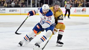 Edmonton Oilers centre Leon Draisaitl (29) and Vegas Golden Knights centre Brett Howden (21) battle for the puck during the second period of an NHL hockey game Tuesday, Feb. 6, 2024, in Las Vegas. (David Becker/AP Photo)