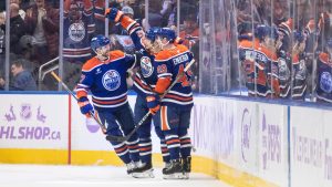 Edmonton Oilers' Brett Kulak (27), Vasily Podkolzin (92) and Ty Emberson (49) celebrate a goal against the New York Rangers during first period NHL action in Edmonton on Saturday, November 23, 2024. (Jason Franson/CP)