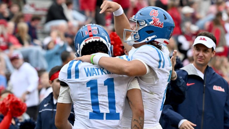 Mississippi quarterback Jaxson Dart (2) celebrates with teammate Jordan Watkins (11) after throwing him a touchdown pass against Arkansas during an NCAA college football game Saturday, Nov. 2, 2024, in Fayetteville, Ark. (Michael Woods/AP)