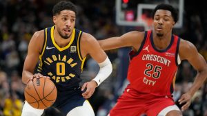 Indiana Pacers' Tyrese Haliburton (0) goes to the basket against New Orleans Pelicans' Trey Murphy III (25) during the first half of an NBA basketball game, Monday, Nov. 25, 2024, in Indianapolis. (AP Photo/Darron Cummings)