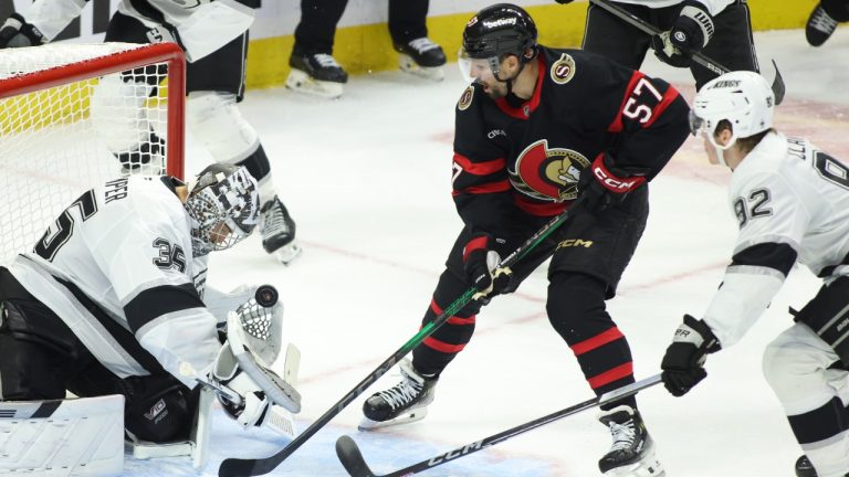 Los Angeles Kings goaltender Darcy Kuemper (35) makes a save in front of Ottawa Senators' David Perron (57) and Kings' Brandt Clarke (92) during third period NHL action in Ottawa, Monday, Oct. 14, 2024. (THE CANADIAN PRESS/ Patrick Doyle)