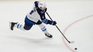 Winnipeg Jets defenceman Neal Pionk shoots and scores on Detroit Red Wings goaltender Alex Lyon during the third period of an NHL hockey game, Wednesday, Oct. 30, 2024, in Detroit. (Carlos Osorio/AP)