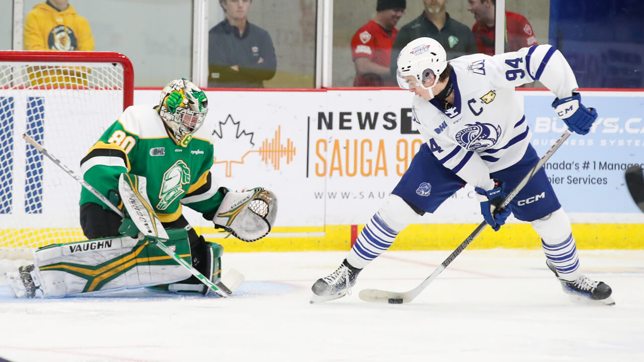 Brampton Steelheads captain Porter Martone handles the puck in front of London Knights goaltender Owen Willmore. (Photo by Luke Durda/OHL Images)