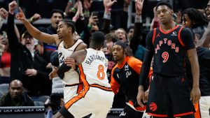 Detroit Pistons guard Jaden Ivey, left, celebrates with forward Tim Hardaway Jr. (8) after making a 2-point basket to defeat the Toronto Raptors as Raptors guard RJ Barrett (9) walks away during the fourth quarter of an NBA basketball game Monday, Nov. 25, 2024, in Detroit. (Duane Burleson/AP)