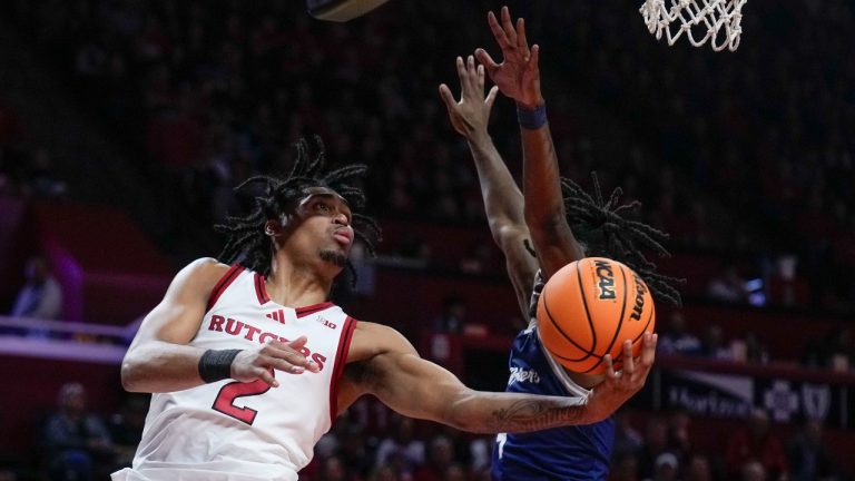 Rutger's Dylan Harper, left, looks to shoot past St. Peter's Adetokunbo Bakare, right, during the second half of an NCAA college basketball game Monday, Nov. 11, 2024, in Piscataway, N.J. (AP Photo/Seth Wenig)