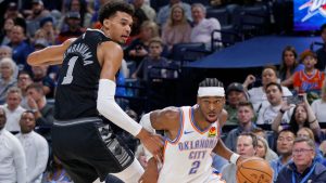 Oklahoma City Thunder guard Shai Gilgeous-Alexander (2) drives past San Antonio Spurs center Victor Wembanyama (1) during the second half of an NBA basketball game, Wednesday, Oct. 30, 2024, in Oklahoma City. (Nate Billings/AP Photo)