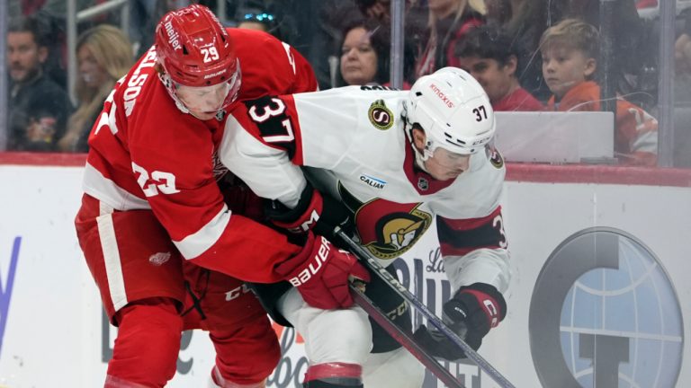 Detroit Red Wings centre Nate Danielson (29) and Ottawa Senators defenceman Donovan Sebrango (37) reach for the puck during the second period of an NHL pre-season hockey game, Friday, Oct. 4, 2024, in Detroit. (Carlos Osorio/AP)