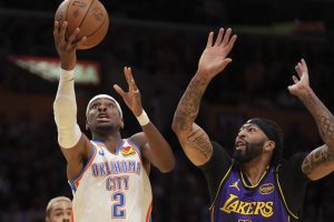 Oklahoma City Thunder guard Shai Gilgeous-Alexander (2) shoots as Los Angeles Lakers forward Anthony Davis, right, defends during the first half of an Emirates NBA Cup basketball game. (Mark J. Terrill/AP)