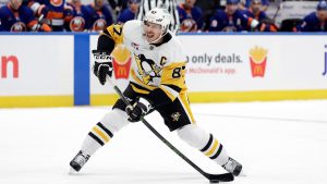 Pittsburgh Penguins center Sidney Crosby (87) shoots in the first period of an NHL hockey game against the New York Islanders Tuesday, Nov. 5, 2024, in Elmont, N.Y. (AP Photo/Adam Hunger)