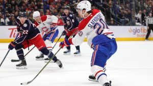 Montreal Canadiens forward Juraj Slafkovsky, right, shoots the puck in front of Columbus Blue Jackets defenseman Jordan Harris during the first period of an NHL hockey game in Columbus, Ohio, Wednesday, Nov. 27, 2024. Slafkovsky scored on the play. (Paul Vernon/AP)