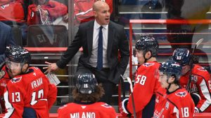 Washington Capitals head coach Spencer Carbery, center top, talks to his team during a third-period timeout of a preseason NHL game against the Philadelphia Flyers, Sunday, Sept. 22, 2024, in Washington. (AP Photo/John McDonnell)