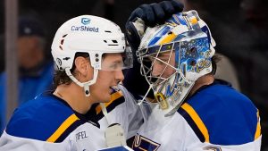 St. Louis Blues center Zack Bolduc (76), left, and goaltender Joel Hofer (30), right, celebrate following an NHL hockey game against the New York Rangers, Monday, Nov. 25, 2024, in New York. The Blues won 5-2. (AP Photo/Julia Demaree Nikhinson)