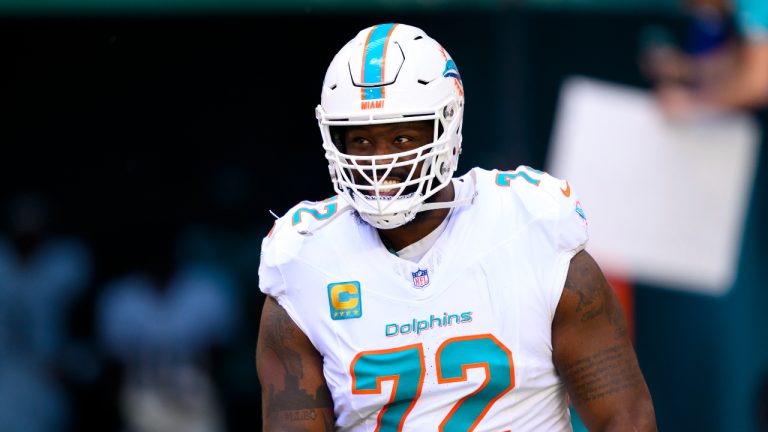 Miami Dolphins tackle Terron Armstead (72) smiles as he runs onto the field during player introduction before an NFL football game. (Doug Murray/AP)