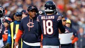 New Chicago Bears offensive coordinator Thomas Brown, left, talks to Chicago Bears quarterback Caleb Williams, right, during the first half of an NFL football game against the Green Bay Packers, Sunday, Nov. 17, 2024, in Chicago. (Kamil Krzaczynski/AP)