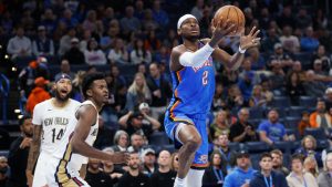 Oklahoma City Thunder guard Shai Gilgeous-Alexander (2) prepares to shoot in front of New Orleans Pelicans forward Brandon Ingram, left, and center Yves Missi, center, during the first half of an NBA basketball game Wednesday, Nov. 13, 2024, in Oklahoma City. (AP Photo/Nate Billings)