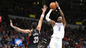 Oklahoma CIty Thunder guard Shai Gilgeous-Alexander (2) shoots over Portland Trail Blazers forward Toumani Camara (33) during the second half of an NBA basketball game, Wednesday, Nov. 20, 2024, in Oklahoma City. (AP Photo/Kyle Phillips)