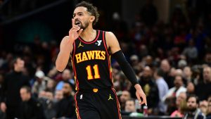 Atlanta Hawks guard Trae Young reacts after a three point basket in the second half of an NBA basketball game against the Cleveland Cavaliers. (David Dermer/AP)