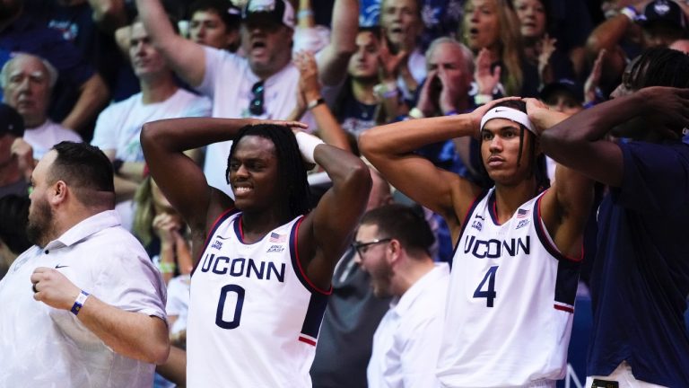 UConn guard Ahmad Nowell (0) reacts with forward Isaiah Abraham (4) on the bench during overtime of an NCAA college game against Memphis at the Maui Invitational Monday, Nov. 25, 2024, in Lahaina, Hawaii. Memphis won 99-97 in overtime. (AP/Lindsey Wasson)