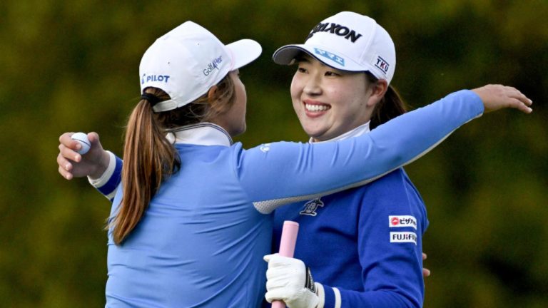 Rio Takeda of Japan, right, gets a hug from Marina Alex of the U.S. as she wins the LPGA's Toto Japan Classic in a playoff at the Seta Golf Course in Otsu, western Japan, Sunday, Nov. 3, 2024. (Keiji Uesho/Kyodo News via AP)