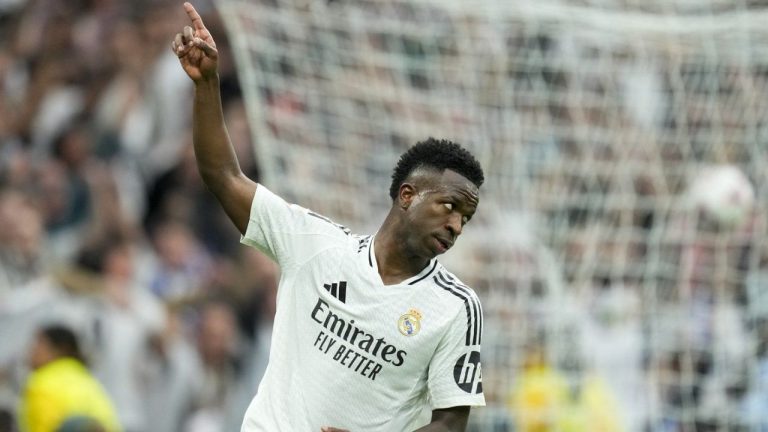 Real Madrid's Vinicius Junior celebrates after scoring his side's first goal during the Spanish La Liga soccer match between Real Madrid and Osasuna at the Santiago Bernabeu stadium in Madrid, Spain, Saturday, Nov. 9, 2024. (Jose Breton/AP Photo)
