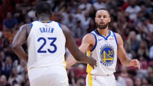 Golden State Warriors forward Draymond Green (23) congratulates guard Stephen Curry (30) after Curry scored during the second half of an NBA basketball game against the Miami Heat, Tuesday, March 26, 2024, in Miami. (AP Photo/Wilfredo Lee)