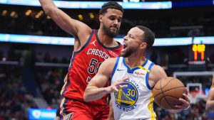 Golden State Warriors guard Stephen Curry (30) drives to the basket against New Orleans Pelicans center Trey Jemison III in the first half of an NBA basketball game in New Orleans, Friday, Nov. 22, 2024. (Gerald Herbert/AP)