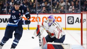 Winnipeg Jets' Mark Scheifele (55) attempts to deflect the puck past Florida Panthers' goaltender Sergei Bobrovsky (72) during second period NHL action in Winnipeg, Tuesday, Nov. 19, 2024. THE CANADIAN PRESS/Fred Greenslade