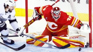 Calgary Flames goalie Dustin Wolf (32) stops a shot by Los Angeles Kings' Phillip Danault during third period NHL hockey action in Calgary, Alta., Monday, Nov. 11, 2024. (Larry MacDougal/CP)