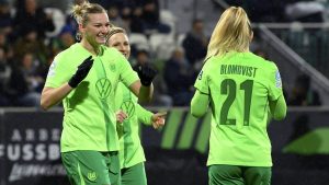 Wolfsburg's scorer Alexandra Popp, left, and her teammates celebrate the opening goal during the Women's Champions League, group A, soccer match between VfL Wolfsburg and Galatasaray A.S. in Wolfsburg, Germany, Wednesday, Nov. 20, 2024. (Swen Pfoertner/dpa via AP)