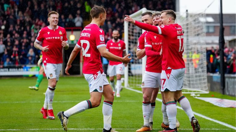 Wrexham players celebrate after scoring their side's second goal during the English League Two soccer match between Wrexham and Stockport at the Racecourse Ground Stadium in Wrexham, Wales, Saturday, April 27, 2024. (Jon Super/AP Photo)