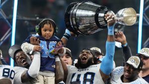 Toronto Argonauts' Wynton McManis (48) hoists the Grey Cup with teammates after defeating the Winnipeg Blue Bombers in the 111th Grey Cup in Vancouver, B.C., Sunday, Nov. 17, 2024. (Frank Gunn/CP)