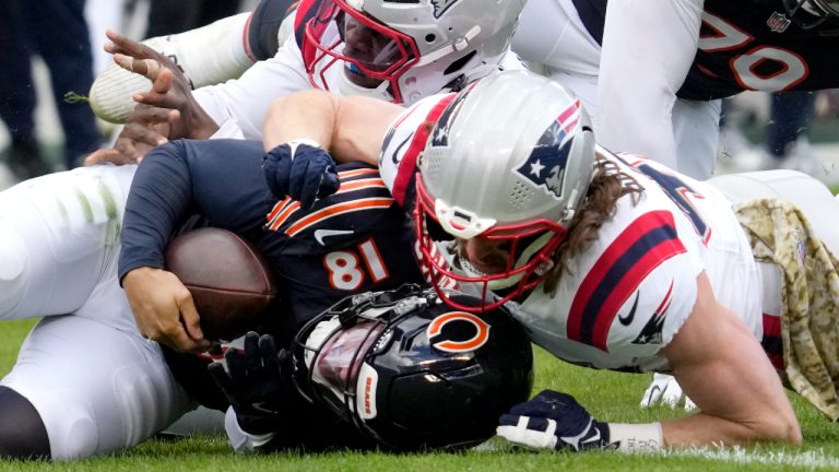 New England Patriots safety Brenden Schooler, right, sacks Chicago Bears quarterback Caleb Williams as linebacker Anfernee Jennings assists during the second half of an NFL football game Sunday, Nov. 10, 2024, in Chicago. (Nam Y. Huh/AP)