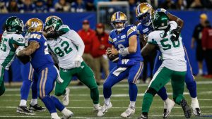 Winnipeg Blue Bombers quarterback Zach Collaros (8) scrambles for the first down against the Saskatchewan Roughriders during the first half of CFL Western Conference Final action in Winnipeg Saturday, November 9, 2024. (John Woods/CP)