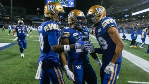 Winnipeg Blue Bombers' Ontaria Wilson (80), Brady Oliveira (20) and Kenny Lawler (89) celebrate Lawlor's touchdown against the Saskatchewan Roughriders during the first half of CFL Western Conference Final action in Winnipeg Saturday, November 9, 2024. (John Woods/CP)