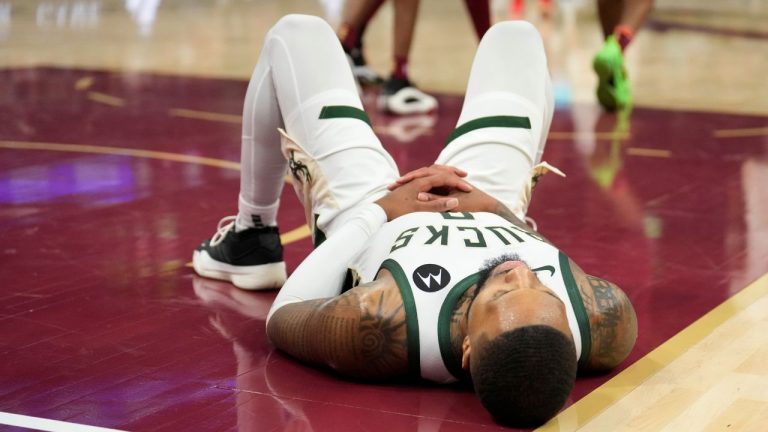 Milwaukee Bucks guard Damian Lillard (0) lies on the court after having a shot blocked late in the second half of an NBA basketball game against the Cleveland Cavaliers, Monday, Nov. 4, 2024, in Cleveland. (Sue Ogrocki/AP Photo)