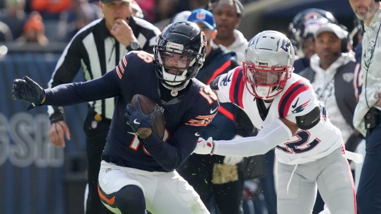 Chicago Bears wide receiver Keenan Allen advances the ball off a pass from quarterback Caleb Williams as New England Patriots cornerback Marco Wilson defends during the first half of an NFL football game Sunday, Nov. 10, 2024, in Chicago. (Nam Y. Huh/AP)