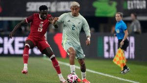 Canada defenceman Alphonso Davies (19) and Mexico defenceman Julian Araujo (2) compete for control of the ball during an international friendly soccer match Tuesday, Sept. 10, 2024, in Arlington, Texas. (Tony Gutierrez/AP)