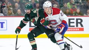 Minnesota Wild centre Marcus Johansson, left, and Montreal Canadiens left wing Juraj Slafkovsky (20) compete for the puck during the first period of an NHL hockey game Thursday, Nov. 14, 2024, in St. Paul, Minn. (Matt Krohn/AP Photo)