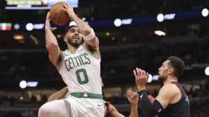 Boston Celtics forward Jayson Tatum (0) drives to the basket abasing Chicago Bulls guard Zach LaVine, right, during the second half of an Emirates NBA Cup basketball game, Friday Nov. 29, 2024, in Chicago. (Melissa Tamez/AP)