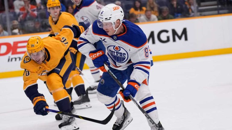 Edmonton Oilers left wing Drake Caggiula (8) skates the puck past Nashville Predators defenseman Brady Skjei (76) during the third period of an NHL hockey game. (George Walker IV/AP)