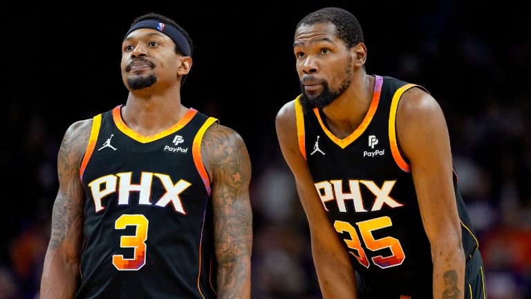 Phoenix Suns guard Bradley Beal (3) and forward Kevin Durant watch a free throw during the second half of Game 3 of an NBA basketball first-round playoff series against the Minnesota Timberwolves, Friday, April 26, 2024, in Phoenix. (Matt York/AP)