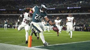 Philadelphia Eagles running back Saquon Barkley (26) scores during the second half of an NFL football game against the Washington Commanders Thursday, Nov. 14, 2024, in Philadelphia. (Matt Slocum/AP)